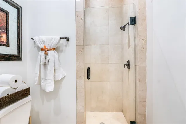 a large white kitchen with granite countertop a sink and dishwasher with white cabinets