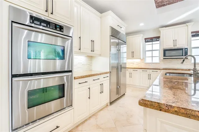 a large kitchen with a table and chairs