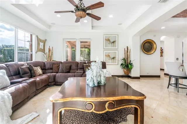 a living room with fireplace furniture and a large window