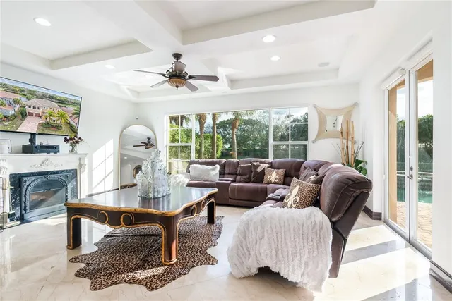 a living room with furniture and a floor to ceiling window
