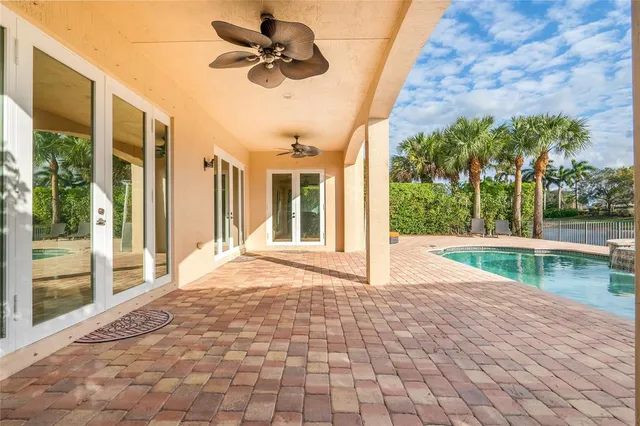an aerial view of a house with swimming pool and outdoor space