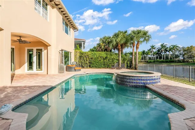 an aerial view of a house with outdoor space and lake view