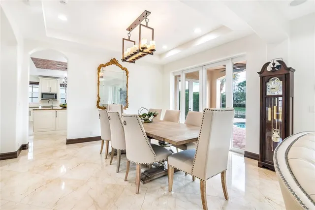 a living room with a bed furniture and a potted plant