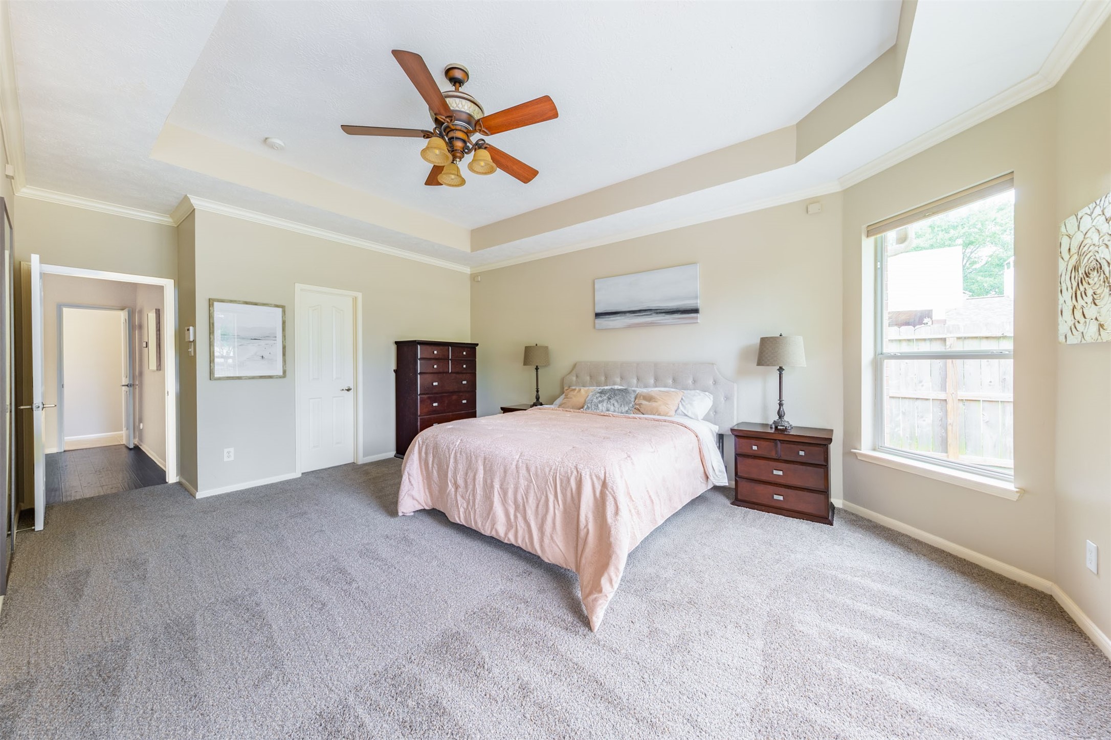 20410 Lake Spring Court Cypress, TX 77433 - Photo 23 of 50 a bedroom with a large bed and a chandelier fan