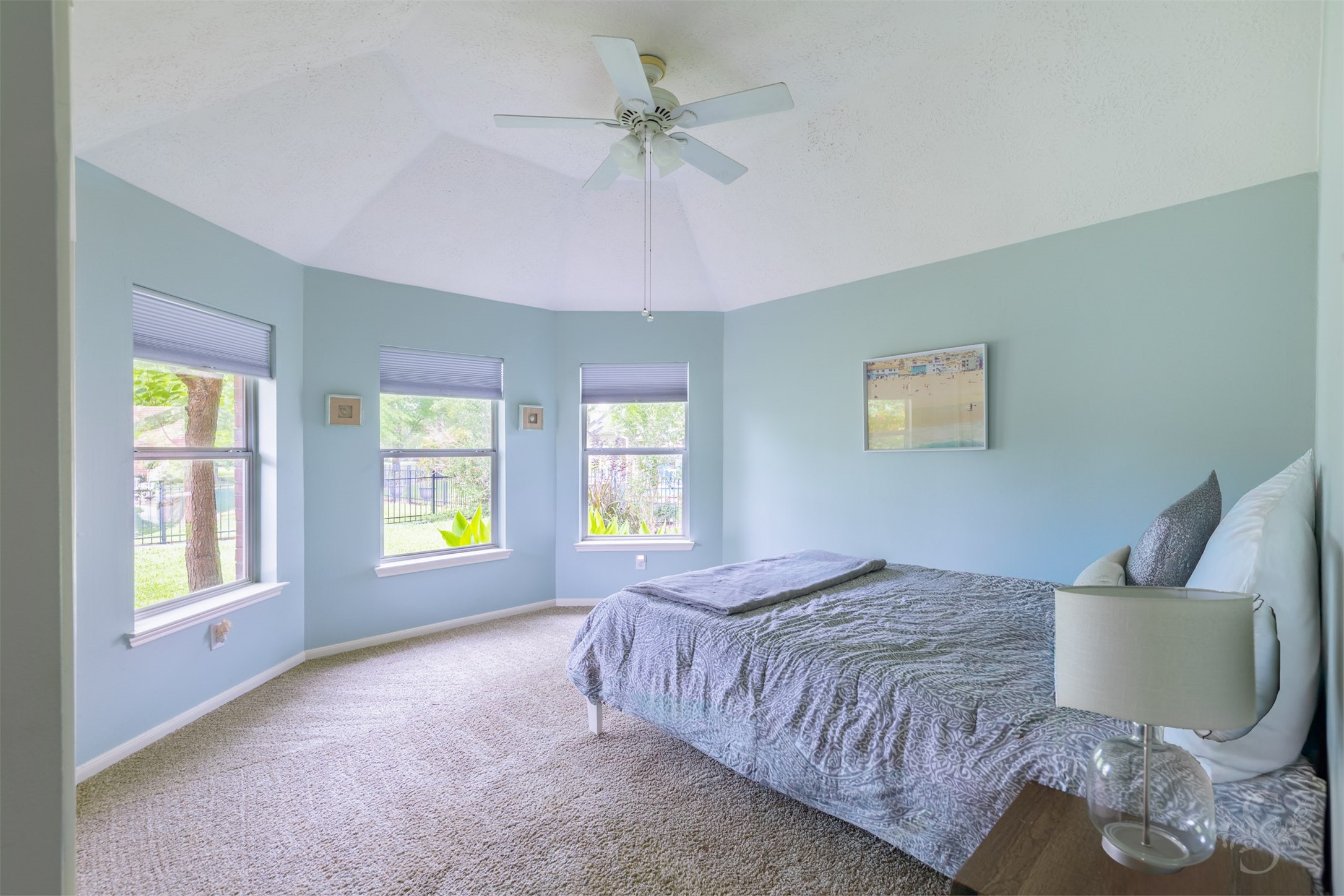 20410 Lake Spring Court Cypress, TX 77433 - Photo 28 of 50 a spacious bedroom with a bed and a chandelier