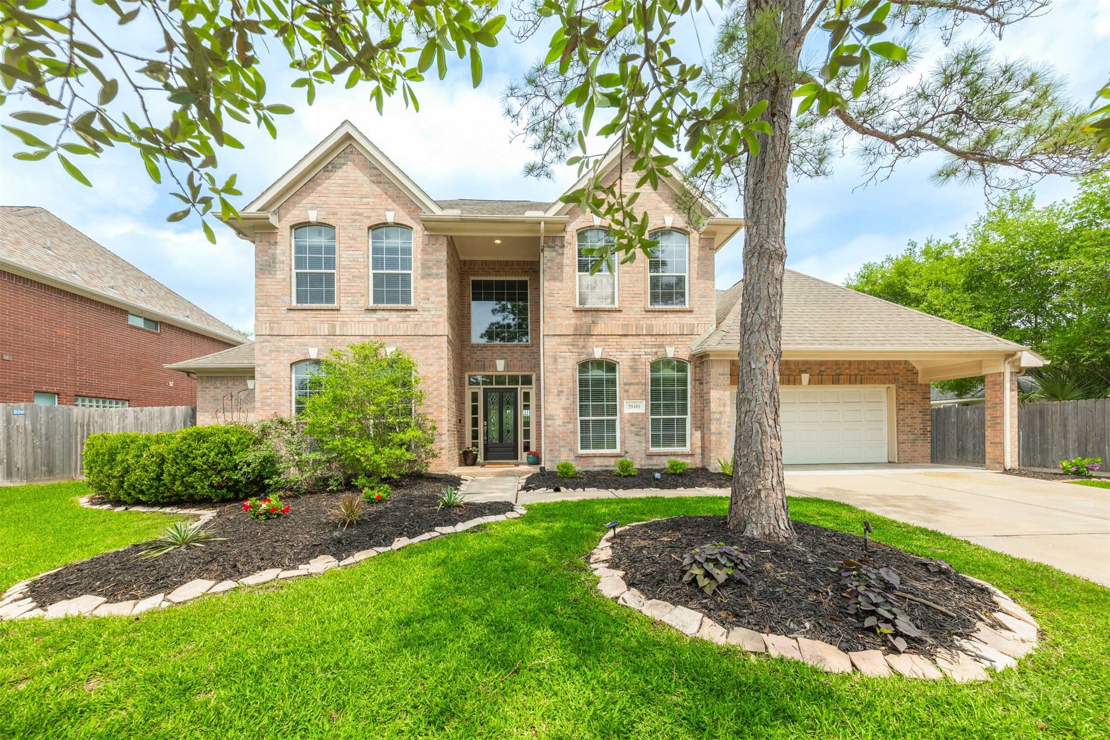 20410 Lake Spring Court Cypress, TX 77433 - Photo 3 of 50 a front view of a house with a yard and trees