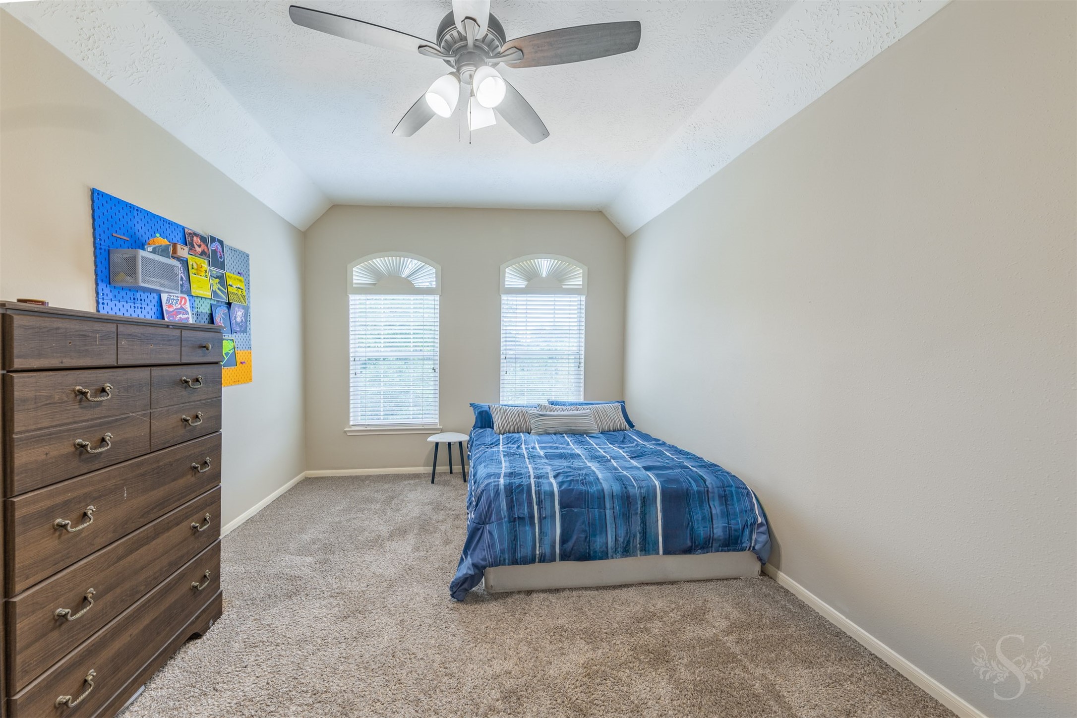 20410 Lake Spring Court Cypress, TX 77433 - Photo 34 of 50 a bedroom with a bed and a chandelier