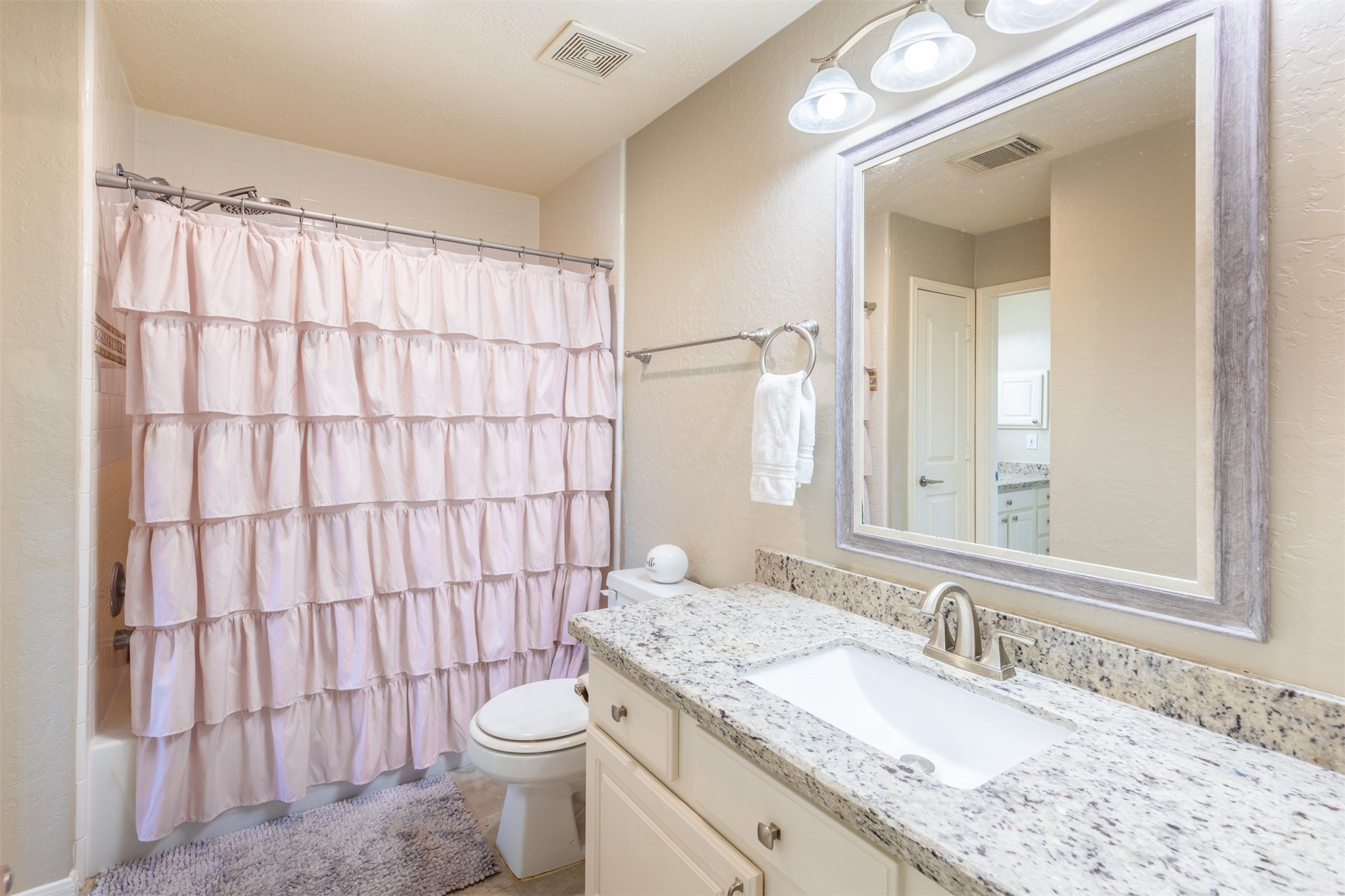 20410 Lake Spring Court Cypress, TX 77433 - Photo 36 of 50 a bathroom with a granite countertop sink toilet and a mirror