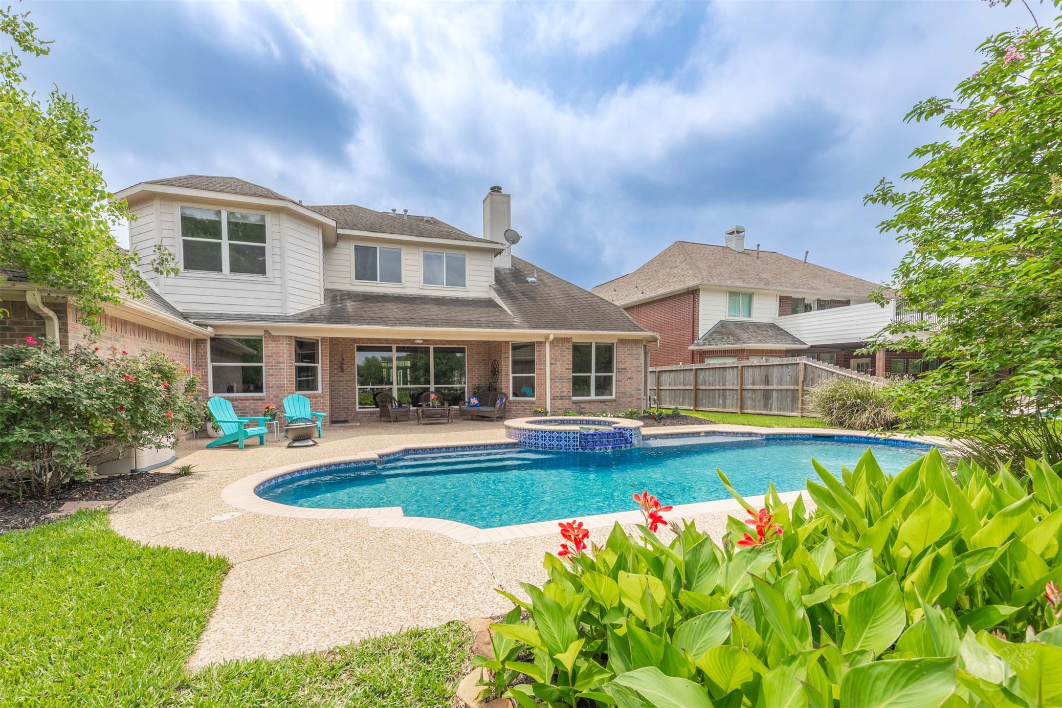 20410 Lake Spring Court Cypress, TX 77433 - Photo 40 of 50 a front view of a house with swimming pool having outdoor seating