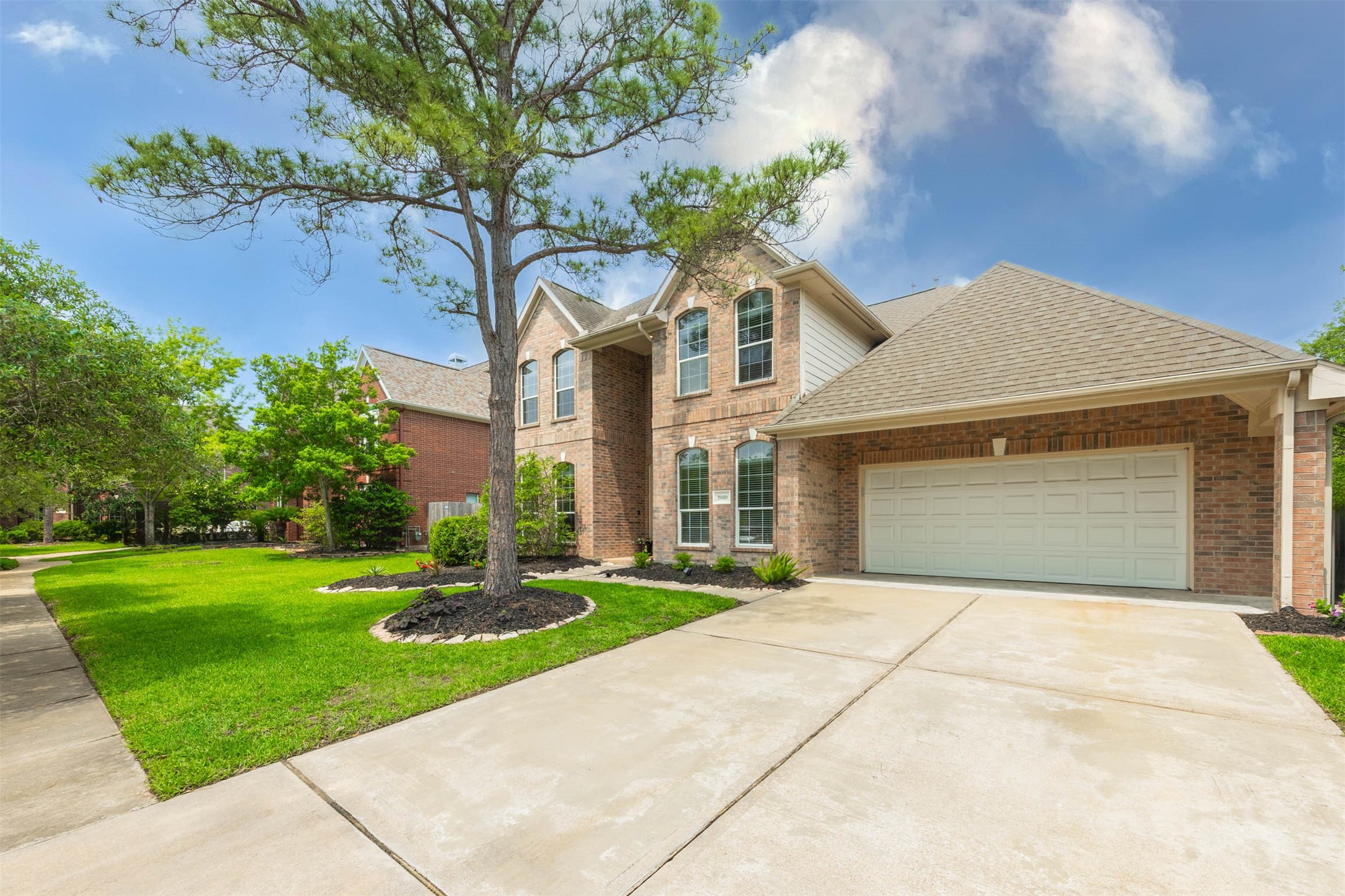 20410 Lake Spring Court Cypress, TX 77433 - Photo 4 of 50 a front view of a house with a yard and trees