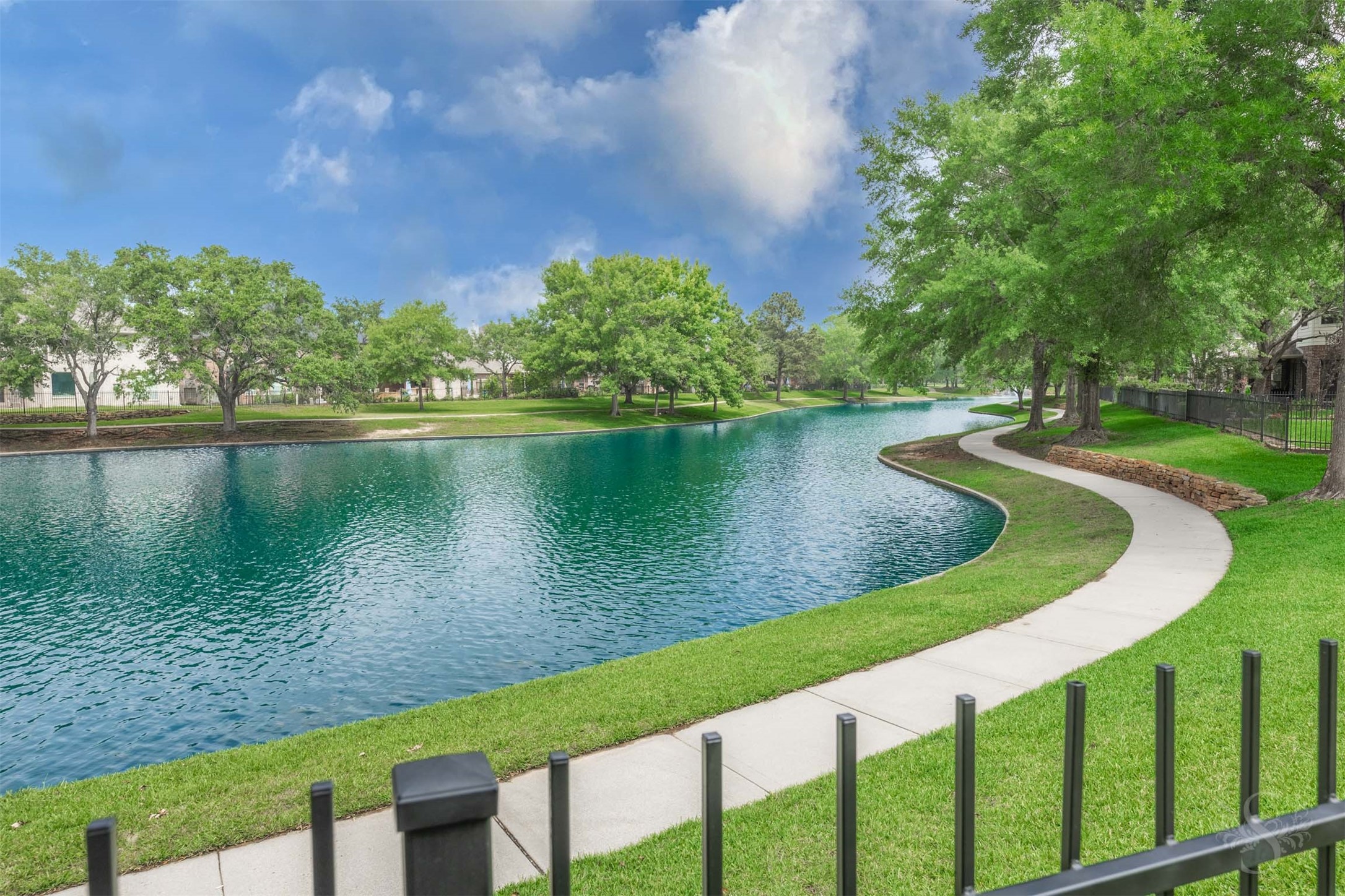 20410 Lake Spring Court Cypress, TX 77433 - Photo 43 of 50 a view of a lake with houses in the back