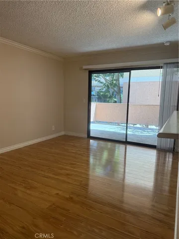 a view of a room with wooden floor