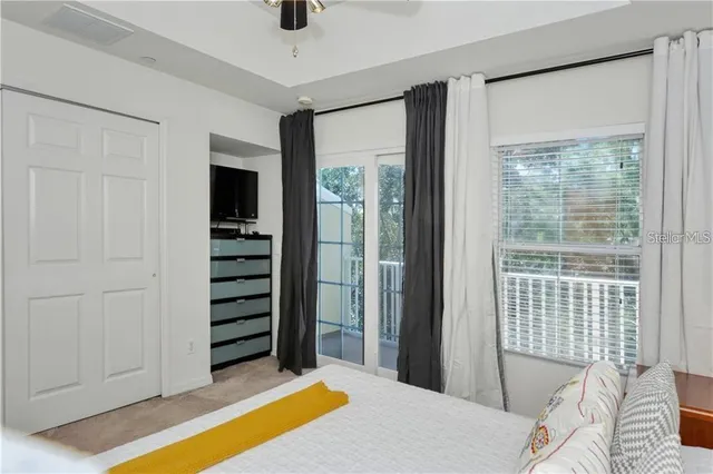 a bedroom with a bed and balcony view