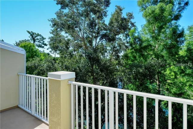 a view of a wooden fence and trees
