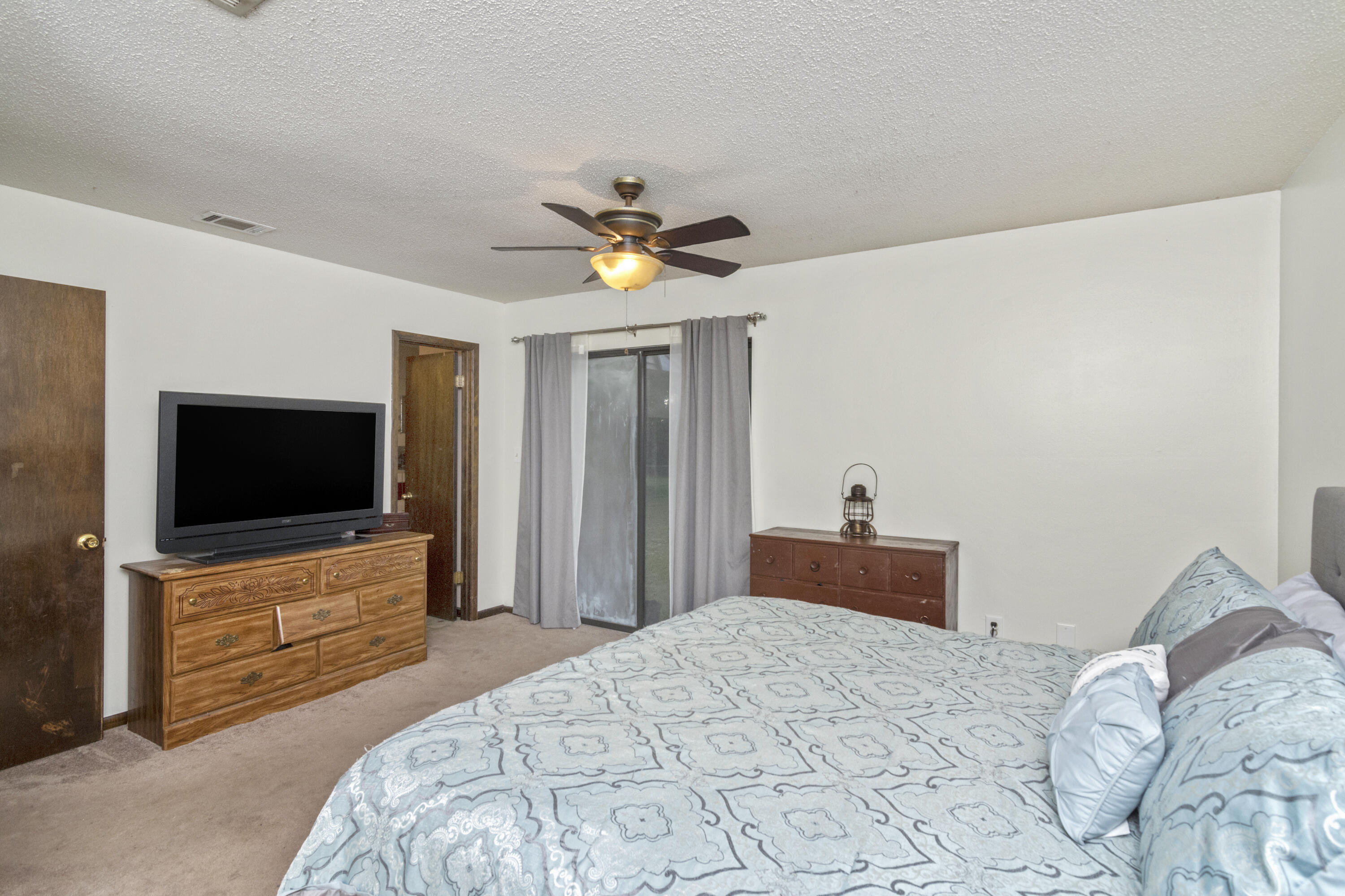 772 Ridge Lake Road Crestview, FL 32536 - Photo 19 of 29 a bedroom with a bed and a flat screen tv