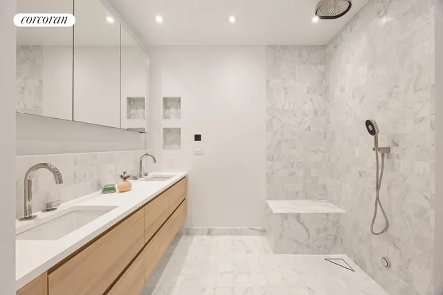 a bathroom with a granite countertop sink a toilet and shower