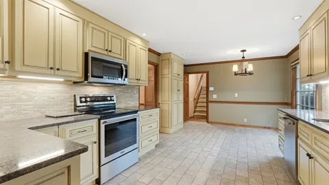 a kitchen with stainless steel appliances a stove sink and microwave
