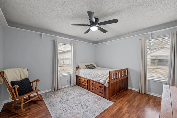 a room with a bed and wooden floor