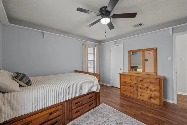 a bedroom with a bed and a dresser