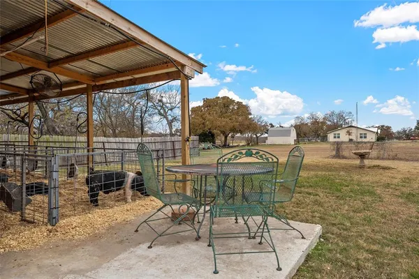 a view of a patio with table and chairs and potted plants