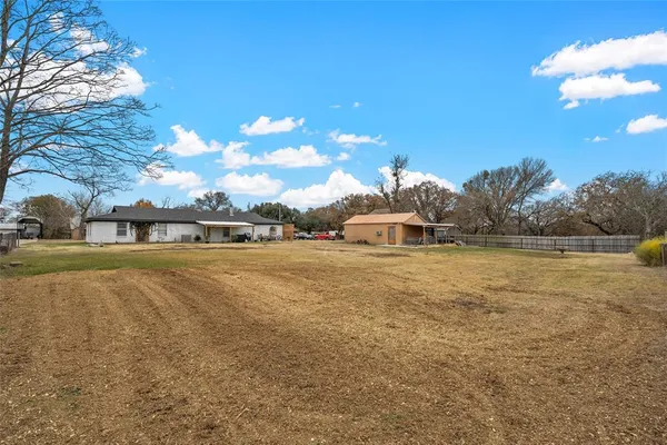 a front view of a house with a yard and swimming pool