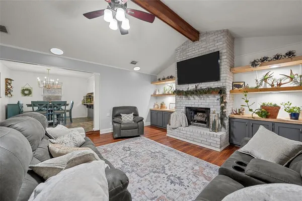 a living room with furniture fireplace and flat screen tv