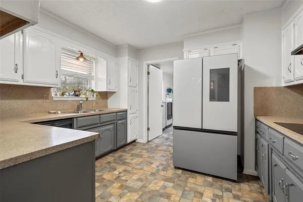 a kitchen with stainless steel appliances a refrigerator sink and cabinets