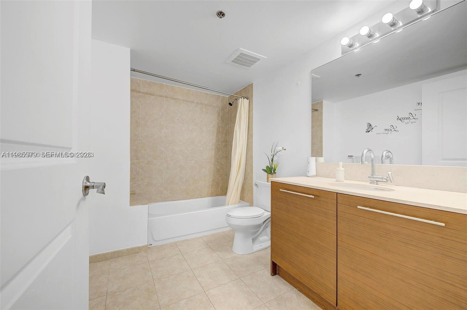 2681 North Flamingo Road, Unit 1201S Sunrise, FL 33323 - Photo 13 of 28 a bathroom with a sink a toilet and shower