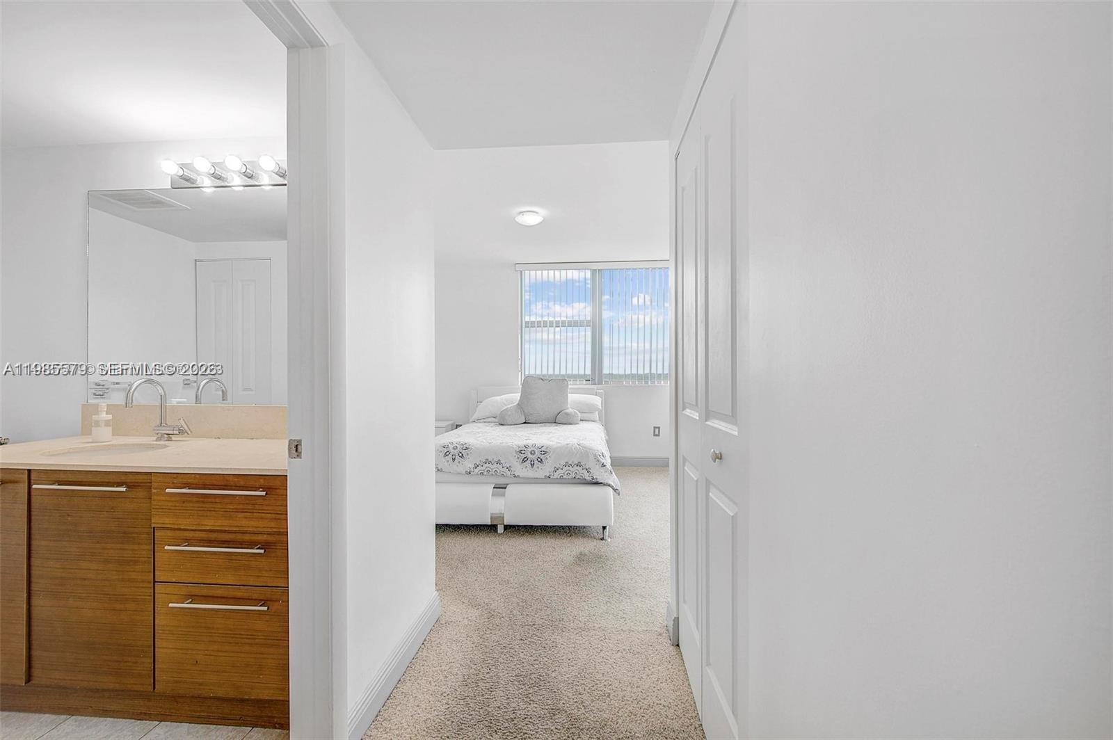 2681 North Flamingo Road, Unit 1201S Sunrise, FL 33323 - Photo 14 of 28 a en suite bathroom with a sink and a mirror