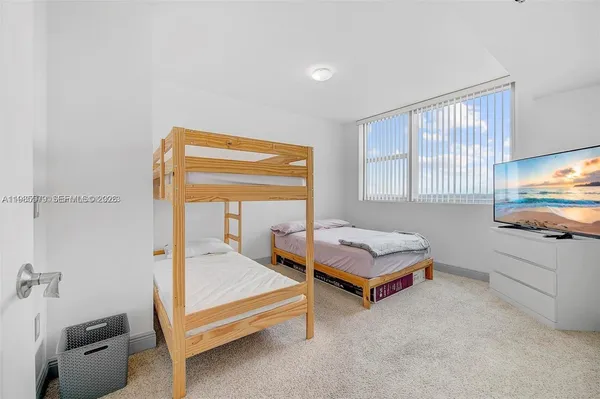 a bedroom with furniture and a tub