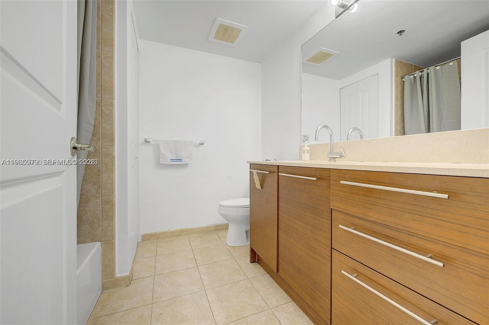 2681 North Flamingo Road, Unit 1201S Sunrise, FL 33323 - Photo 16 of 28 a bathroom with a sink a toilet and shower