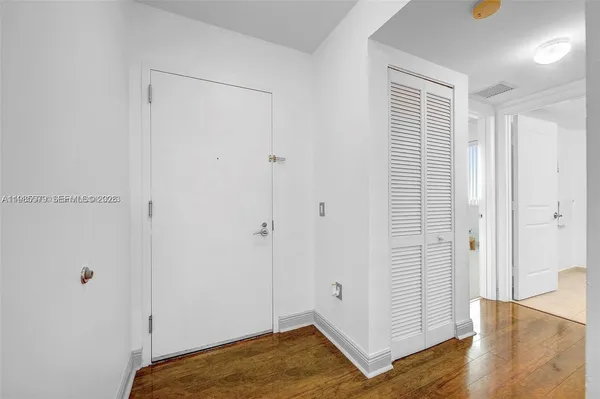 a view of a bedroom with wooden floor