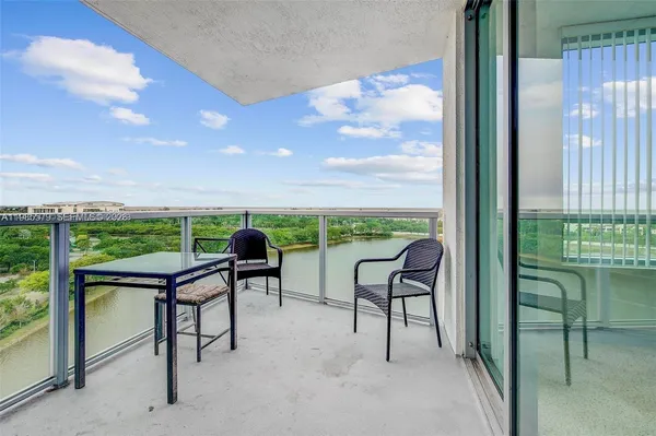 a view of a terrace with furniture and a garden