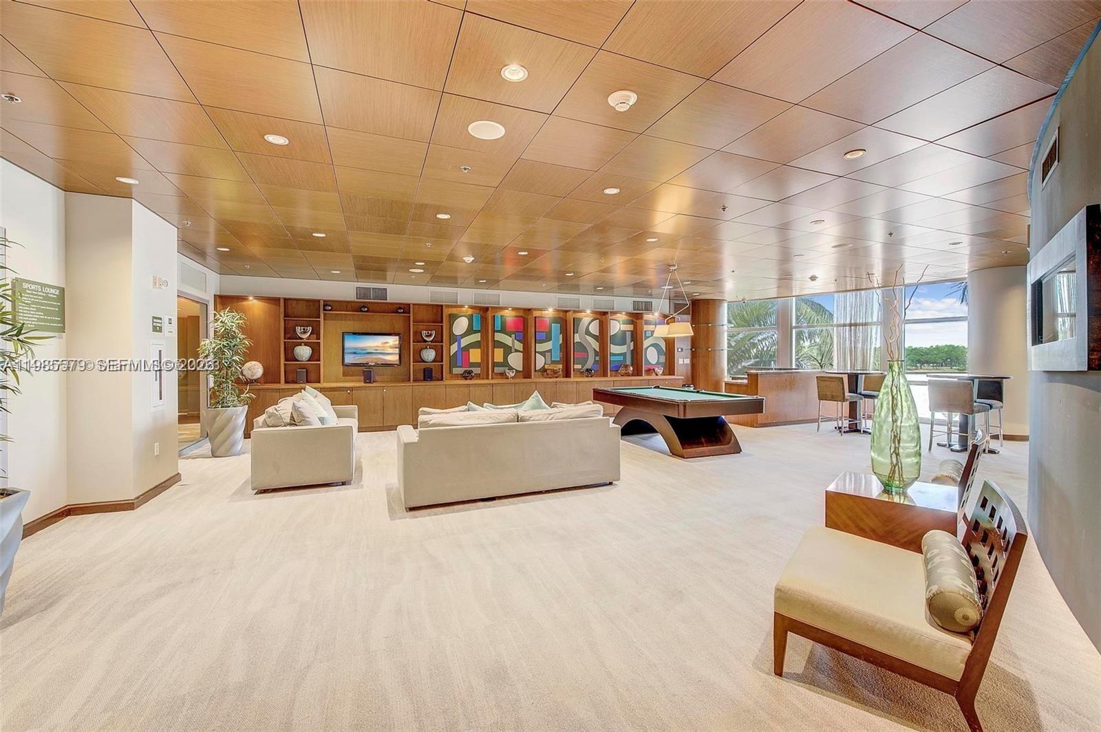 2681 North Flamingo Road, Unit 1201S Sunrise, FL 33323 - Photo 20 of 28 a living room with furniture and a flat screen tv