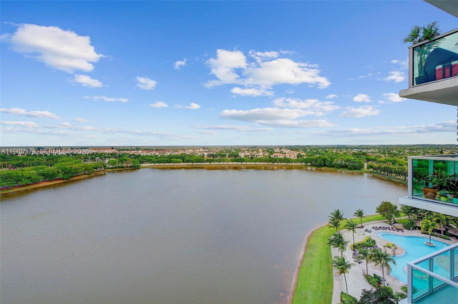 2681 North Flamingo Road, Unit 1201S Sunrise, FL 33323 - Photo 22 of 28 a view of a lake with a table and chairs