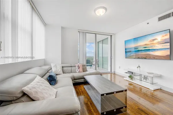 a living room with furniture and a flat screen tv