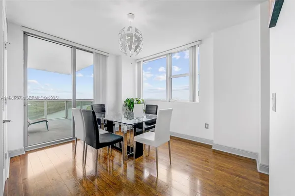 a view of a dining room with furniture window and wooden floor