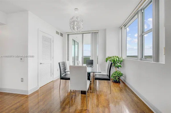 a view of a dining room with furniture window and wooden floor
