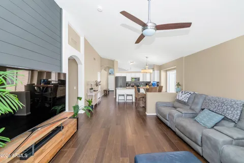 a living room with furniture and a wooden floor