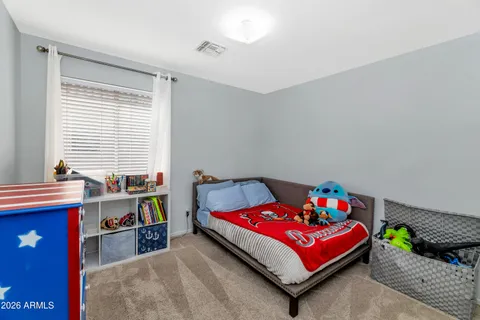 a bedroom with a bed and a desk