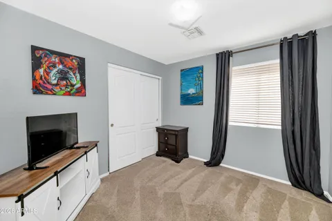 a bedroom with a bed and a flat screen tv
