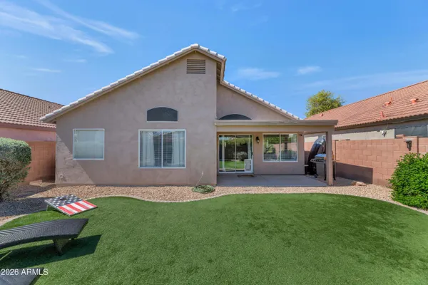 a front view of a house with a garden and yard