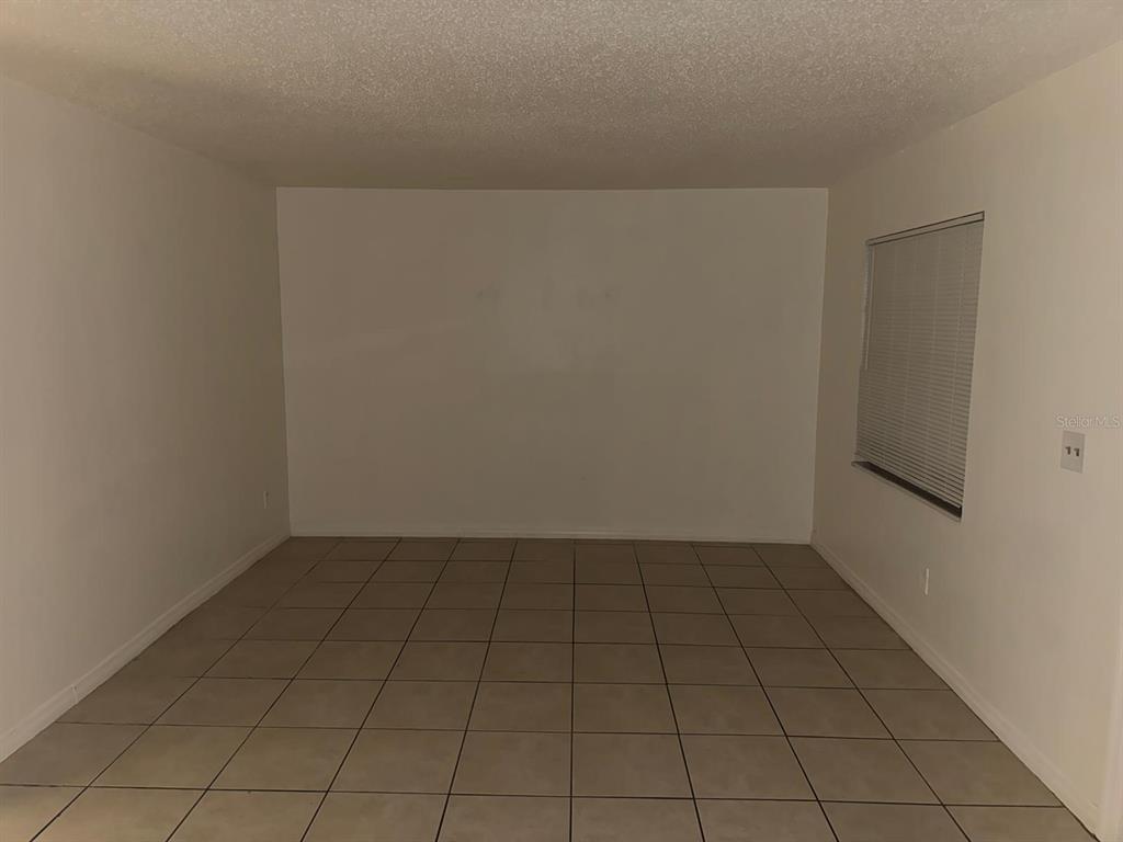 719 Michigan Court, Unit 3 St. Cloud, FL 34769 - Photo 5 of 16 an empty room with white door