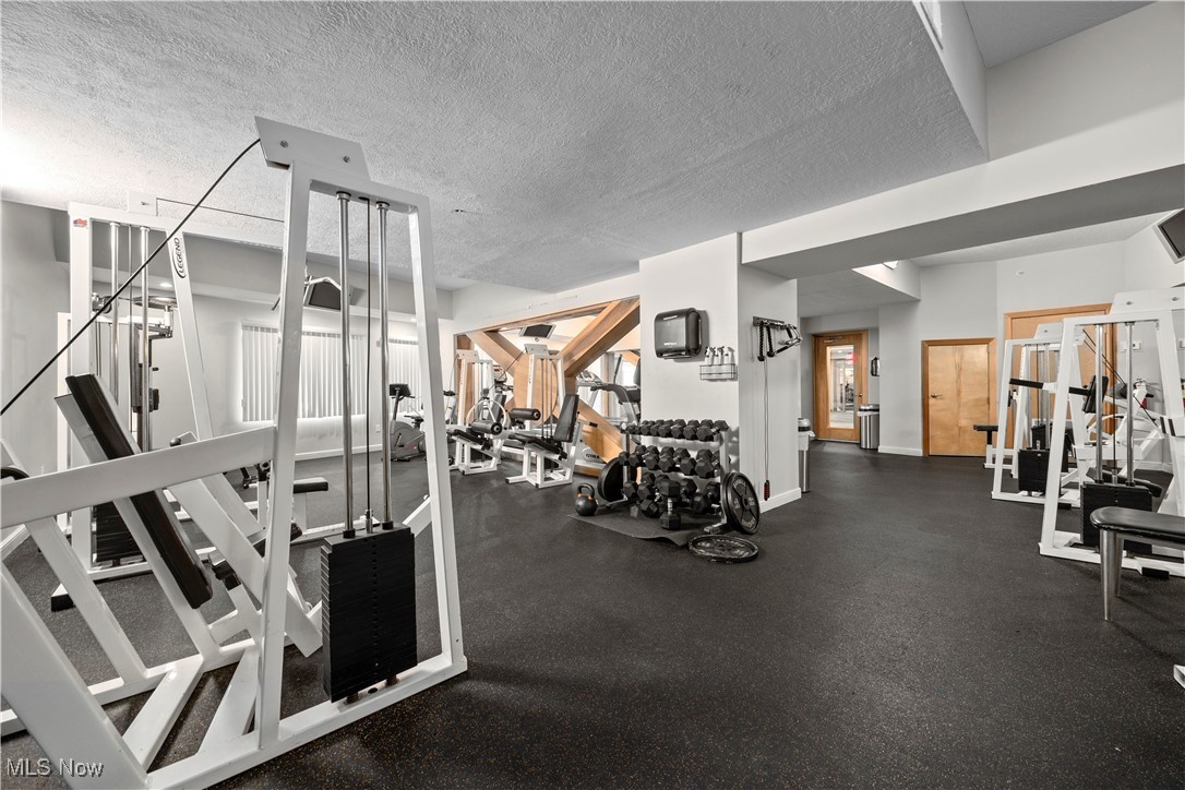 2222 Detroit Avenue, Unit 519 Cleveland, OH 44113 - Photo 5 of 30 Exercise room featuring a textured ceiling and baseboards