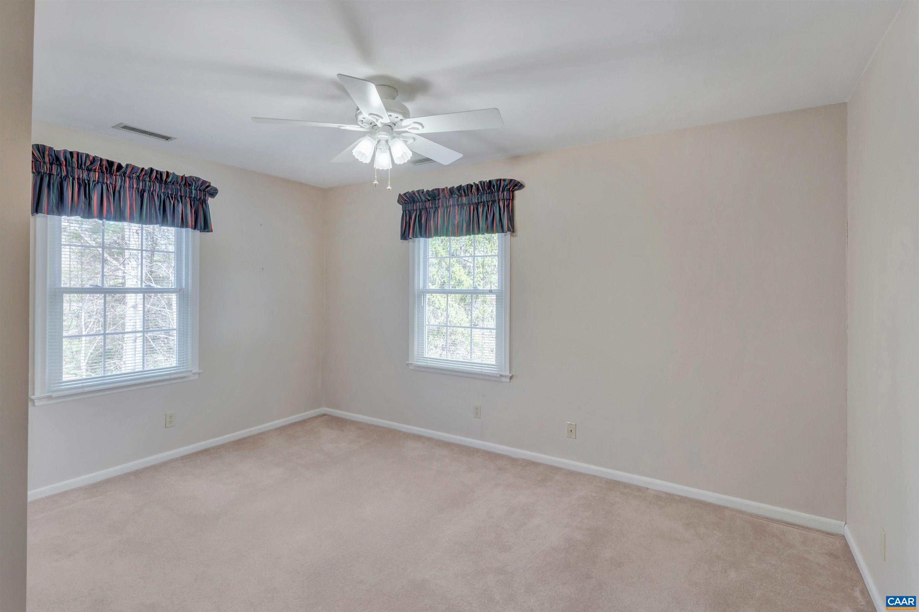 2091 Whippoorwill Road Charlottesville, VA 22901 - Photo 20 of 41 an empty room with windows and fan