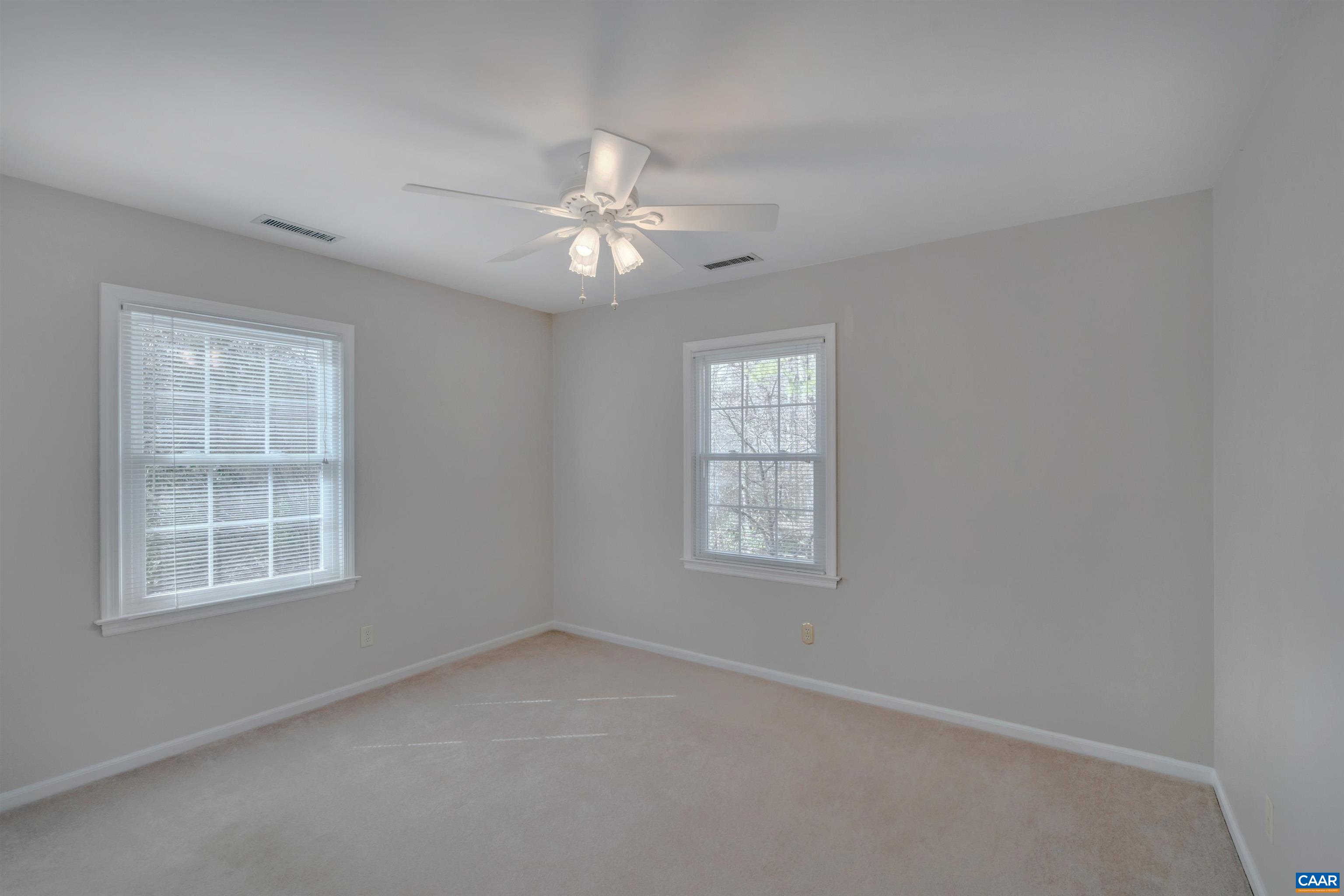2091 Whippoorwill Road Charlottesville, VA 22901 - Photo 21 of 41 an empty room with windows and ceiling fan