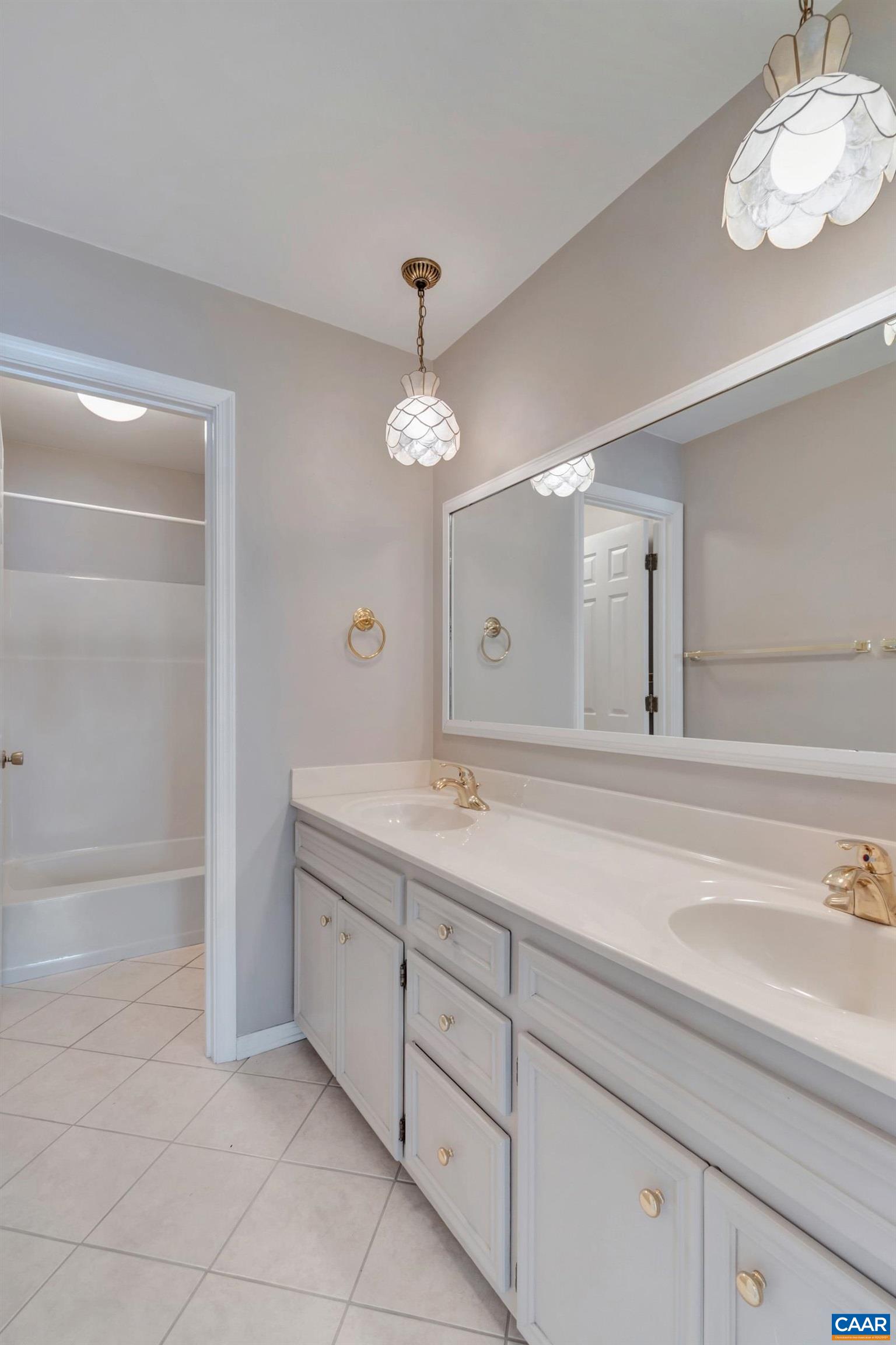 2091 Whippoorwill Road Charlottesville, VA 22901 - Photo 23 of 41 a bathroom with a sink a large mirror and a shower
