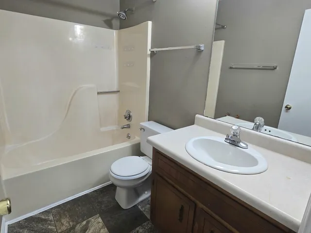 a bathroom with a sink toilet and a mirror