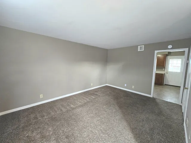 an empty room with a empty space and windows