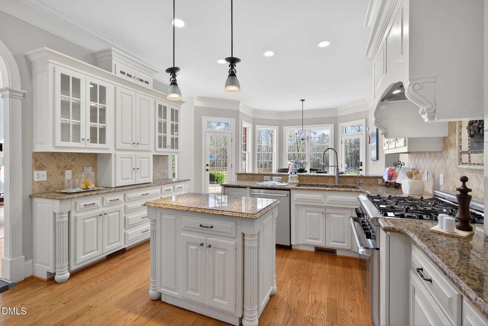 1609 Holland Road Fuquay-Varina, NC 27526 - Photo 15 of 79 a kitchen with granite countertop a sink stove and cabinets